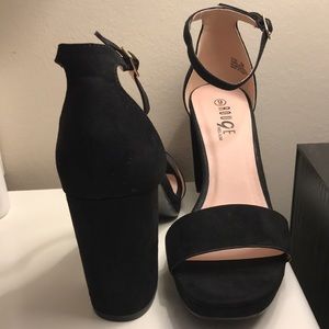 Black velvet heels with gold clip and thin strap.